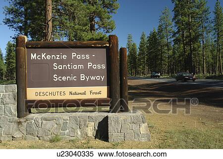 Stock Photography -  Bend, OR, Oregon, Deschutes National Forest, McKenzie Pass, Santiam Pass, Oregon Scenic Byway, entrance, wooden road sign. Fotosearch