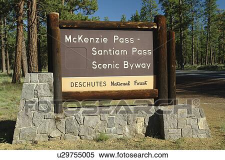 Stock Photography -  Bend, OR, Oregon, Deschutes National Forest, McKenzie Pass, Santiam Pass, Oregon Scenic Byway, entrance, wooden road sign. Fotosearch