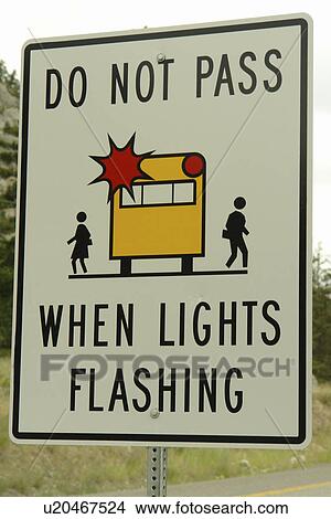 Picture -  British Columbia, Canada, Do Not Pass When Lights are Flashing, School Bus road sign. Fotosearch
