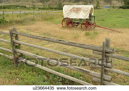 Stock Photography -  Cachet Creek, British Columbia, Canada, Historic Hat Creek Ranch, covered wagon, entrance sign. Fotosearch