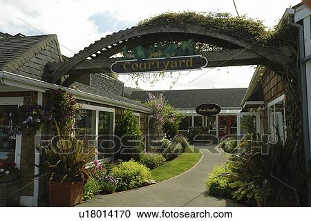 Stock Image -  Cannon Beach, OR, Oregon, Pacific Ocean, Pacific Coast Scenic Byway, Rt Route, Highway 101, downtown, Courtyard. Fotosearch