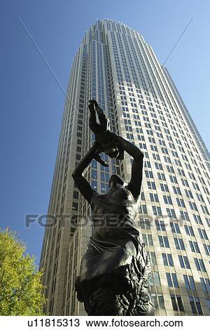 Stock Image -  Charlotte, NC, North Carolina, Downtown, The Square, Mother lifting child to sky bronze statue hope for city's future. Fotosearch