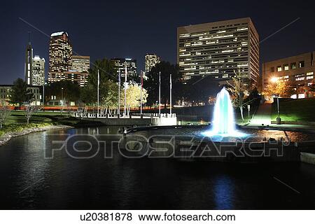 Stock Photo -  Charlotte, NC, North Carolina, Downtown Skyline, Marshall Park, fountain, evening. Fotosearch
