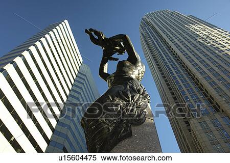Stock Photography -  Charlotte, NC, North Carolina, Downtown, The Square, Mother lifting child to sky bronze statue hope for city's future. Fotosearch