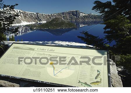 Stock Image -  Crater Lake National Park, OR, Oregon, Cascade Range, Volcanic Legacy Scenic Byway, Rim Drive, Wizard Island, overlook, interpretive sign. Fotosearch