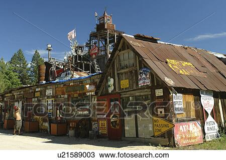 Stock Image -  Idaho City, ID, Idaho, Ponderosa Pine Scenic Byway, Gold Mining Town, building covered with old signs. Fotosearch