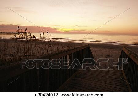 Stock Image -  Myrtle Beach, SC, South Carolina, The Grand Strand, beach, sunrise, boardwalk. Fotosearch