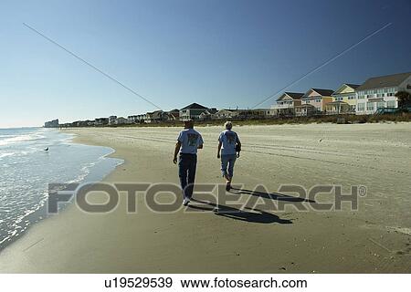 Myrtle Beach, SC, South Carolina, The Grand Strand, couple walking on the beach View Large Photo Image Stock Photo - Myrtle Beach, SC, South Carolina, The Grand Strand, couple walking on the beach. Fotosearch
