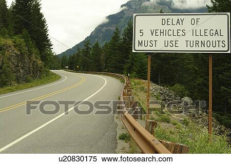Stock Photography -  North Cascades, WA, Washington, Okanogan National Forest, Ross Lake National Recreation Area, National Park Service Complex, road sign, delay of 5 vehicles illegal must use turnouts. Fotosearch