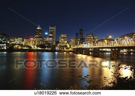 Stock Photograph -  Portland, OR, Oregon, Willamette River, Hawthorne Lift Bridge, downtown, skyline, evening. Fotosearch