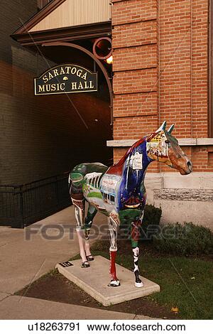 Stock Image -  Saratoga Springs, NY, New York, Historic Downtown, Saratoga Music Hall, horse statue. Fotosearch