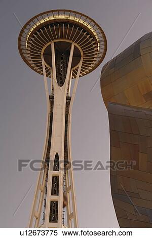 Stock Photography -  Seattle, WA, Washington, Seattle Center, Space Needle, Experiment Music Project, Frank O. Gehry designed building, evening. Fotosearch