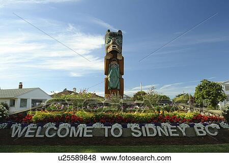 Sidney, British Columbia, Canada, Vancouver Island, Strait of Georgia, Welcome to Sidney BC floral sign, totem pole View Large Photo Image Stock Photo - Sidney, British Columbia, Canada, Vancouver Island, Strait of Georgia, Welcome to Sidney BC floral sign, totem pole. Fotosearch