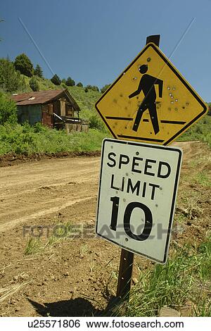 Silver City, ID, Idaho, Ghost Town, pedestrian crossing sign full of bullet holes, speed limit sign, 10 miles per hour, dirt road View Large Photo Image Stock Photograph - Silver City, ID, Idaho, Ghost Town, pedestrian crossing sign full of bullet holes, speed limit sign, 10 miles per hour, dirt road. Fotosearch
