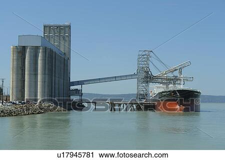 Stock Image -  Tacoma, WA, Washington, Puget Sound, Commencement Bay, Tacoma Harbor, grain elevator, freighter. Fotosearch