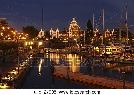 Stock Photo -  Victoria, British Columbia, Canada, Vancouver Island, Inner Harbour, Parliament Buildings, waterfront, marina, evening. Fotosearch
