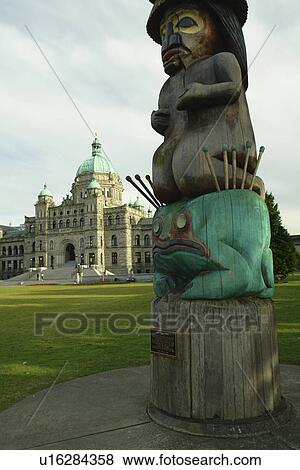 Stock Photo -  Victoria, British Columbia, Canada, Vancouver Island, Parliament Buildings, totem pole. Fotosearch