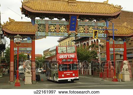 Stock Photo -  Victoria, British Columbia, Canada, Vancouver Island, Chinatown, red double-decker tour bus. Fotosearch