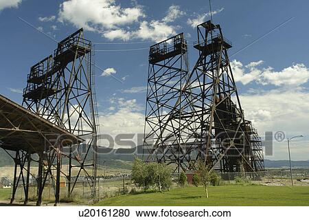 Stock Image -  Butte, MT, Montana, Berkeley Pit, old open pit mine, mine shaft, mine headframe. Fotosearch