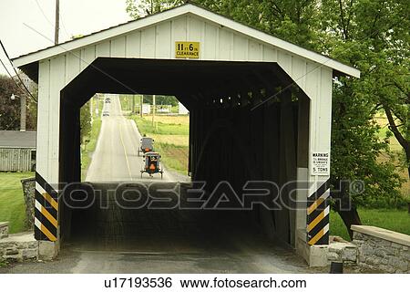 Stock Photograph -  Gap, PA, Pennsylvania, Pennsylvania Dutch Country, Amish, horse and buggy, road, covered bridge. Fotosearch