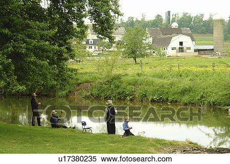 Stock Photography -  Gap, PA, Pennsylvania, Pennsylvania Dutch Country, Amish, farm, men and boys fishing in river. Fotosearch