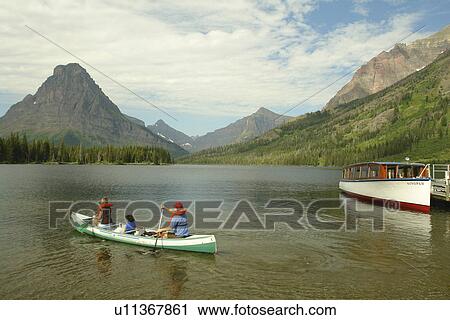 Stock Image -  Glacier National Park, MT, Montana, Rocky Mountains, Two Medicine Lake, canoeing. Fotosearch