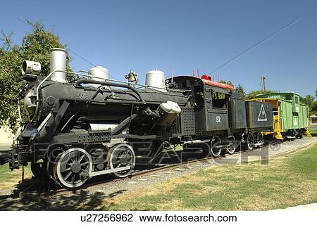 Stock Image -  Lewiston, ID, Idaho, city park, train, steam locomotive, green caboose. Fotosearch