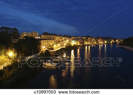 Stock Image -  Manistee, MI, Michigan, Lake Michigan, Manistee River, waterfront, evening. Fotosearch
