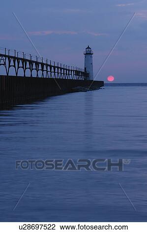 Stock Image -  Manistee, MI, Michigan, Lake Michigan, North Pierhead Lighthouse, sunset. Fotosearch