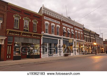 Stock Image -  Manistee, MI, Michigan, River Street, Historic Downtown, evening. Fotosearch