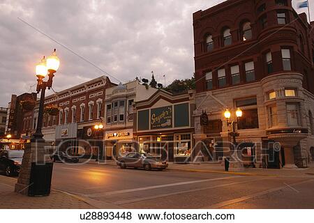 Stock Photo -  Manistee, MI, Michigan, River Street, Historic Downtown, evening. Fotosearch