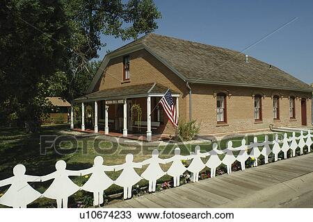 Stock Image -  Medora, ND, North Dakota, Historic Medora, downtown, Medora Doll House, white fence, paper dolls. Fotosearch