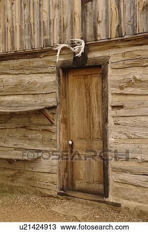 Stock Image -  Medora, ND, North Dakota, Theodore Roosevelt National Park, South Unit, Visitor Center, Teddy Roosevelt's first ranch Maltese Cross log cabin, close-up. Fotosearch