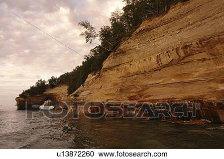 Stock Image -  Munsing, MI, Michigan, Upper Peninsula, Lake Superior, Pictured Rocks Boat Cruise, Pictured Rocks National Lakeshore, sunset. Fotosearch