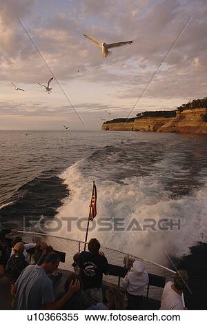 Munsing, MI, Michigan, Upper Peninsula, Lake Superior, Pictured Rocks Boat Cruise, Pictured Rocks National Lakeshore, sunset, passengers, seagulls flying View Large Photo Image Stock Photography - Munsing, MI, Michigan, Upper Peninsula, Lake Superior, Pictured Rocks Boat Cruise, Pictured Rocks National Lakeshore, sunset, passengers, seagulls flying. Fotosearch