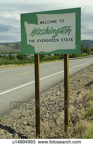 Stock Image -  Oroville, WA, Washington, Welcome to Washington State The Evergreen State road sign. Fotosearch