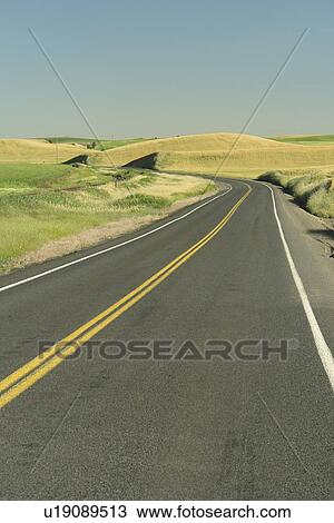 Stock Image -  The Palouse Country, WA, Washington, Whitman County, rolling hills, scenic drive, road. Fotosearch