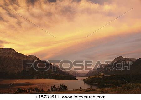 Stock Image -  Waterton Lakes National Park, Alberta, Canada, Rocky Mountains, Prince of Wales Hotel, Upper and Middle Waterton Lakes, sunrise. Fotosearch