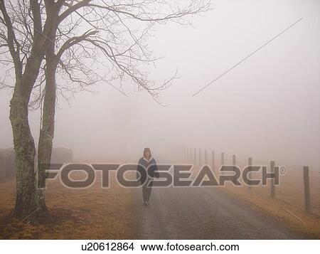 Picture -  woman walking, dirt road, fog, Galax, Virginia, VA. Fotosearch