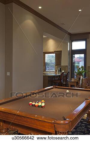 Stock Image - Billiard table leading onto dining area. Fotosearch