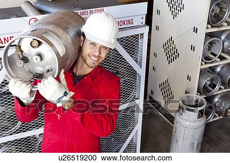 Hispanic worker inspecting gas canister View Large Photo Image Stock Image - Hispanic worker inspecting gas canister. Fotosearch