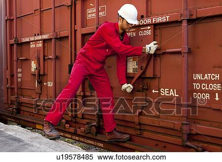 Hispanic worker opening industrial railway carriage View Large Photo Image Stock Photography - Hispanic worker opening industrial railway carriage. Fotosearch