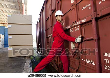 Hispanic worker opening industrial railway carriage View Large Photo Image Stock Photography - Hispanic worker opening industrial railway carriage. Fotosearch