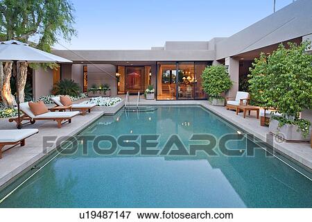 House exterior with pool at dusk View Large Photo Image Stock Photo - House exterior with pool at dusk. Fotosearch