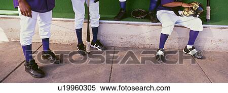 Low section of baseball player preparing for match in dugout View Large Photo Image Stock Photography - Low section of baseball player preparing for match in dugout. Fotosearch