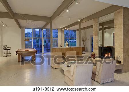 Stock Image - Luxurious living area with billiard table. Fotosearch