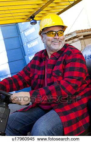 Man driving fork lift truck View Large Photo Image Stock Photography - Man driving fork lift truck. Fotosearch