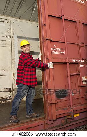 Middle aged worker opening metal railway carriage door View Large Photo Image Stock Photography - Middle aged worker opening metal railway carriage door. Fotosearch