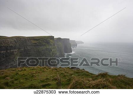 Stock Image - Misty view over Cliffs of Moher. Fotosearch