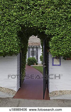 Stock Photograph - Open gate leading to bungalow. Fotosearch